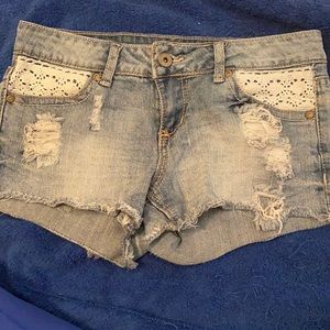 Denim distressed shorts with white lace